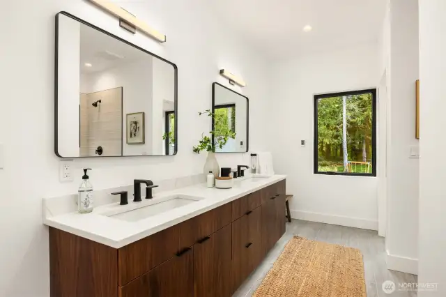 Primary bath with walnut double vanity, quartz counters, walk-in closet, shower and water closet with bidet.