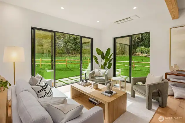 Three sets of sliding doors brings nature into your the living space. Gorgeous engineered oak hardwoods lend to the coziness.