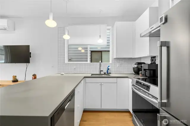 Modern kitchen equipped with plenty of storage and full sized appliances.
