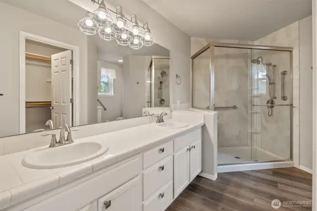 Primary Suite 3/4 Bathroom with dual vanity, walk-in closet, walk-in shower with clear easy entry doors and separate toilet room!
