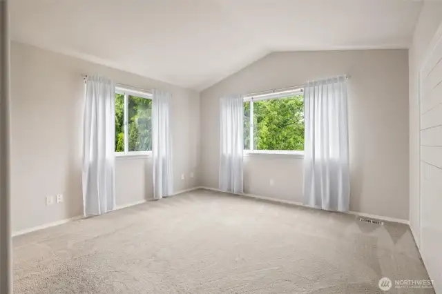 Primary Suite has large dual windows for light galore! Plus a shiplap wall backdrop for headboard accenting!