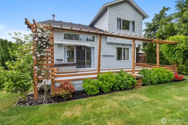 Absolutely gorgeous landscaping accents the deck trellising! Notice the hidden shades on the trellising for summer shade and also the awnings over the slider/hot tub!