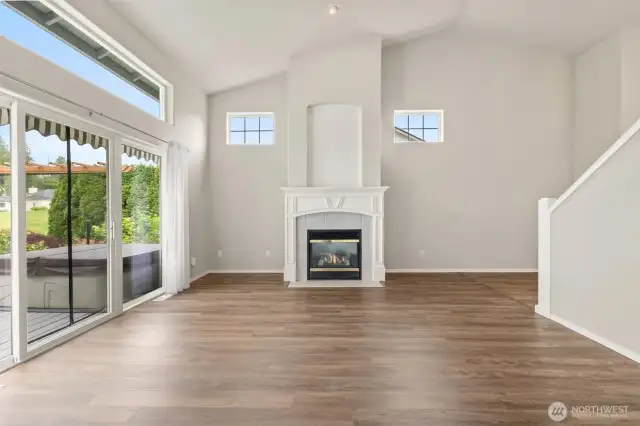 Large living room with slider out to the large entertainment deck. Awnings and shades for summer days! For winter days - cozy up to the fire!