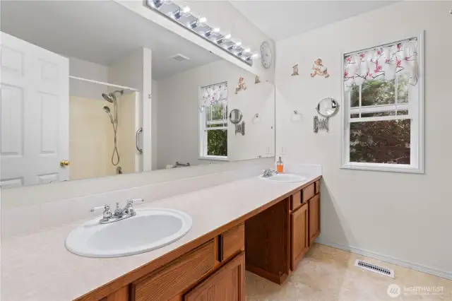 Primary ensuite bathroom with a double vanity.