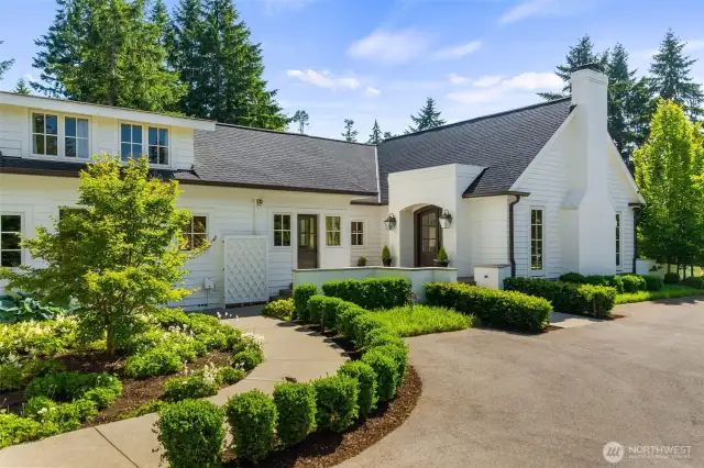 Follow the charming path from your three-car garage to the welcoming front door.