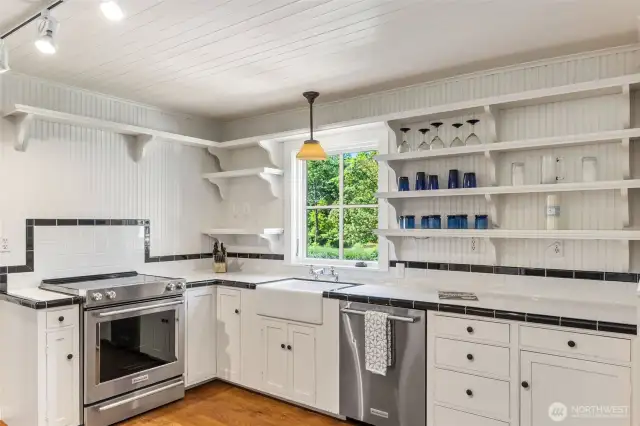 Second kitchen equipped with KitchenAid appliances and a stunning deep farmhouse sink.