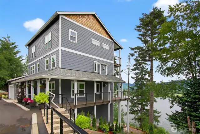 Landscaping  provides for parking, stair down to the backyard, and a large patio with firepit.