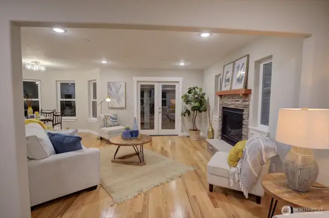 Looking from the library room into the living room with a nice gas fireplace.