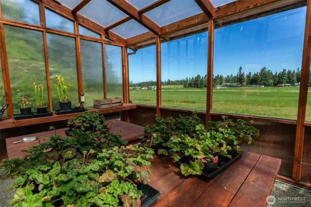 Wonderful views overlooking pasture below. Bespoke Greenhouse made of Juniper wood, with a Dutch door, double-paned window, shelves, and raised beds nearby.