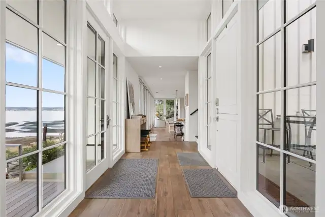 The gracious primary suite offers soaring ceilings, Lutron blackout blinds for restful nights, and French doors that open onto the eco-friendly sundeck.