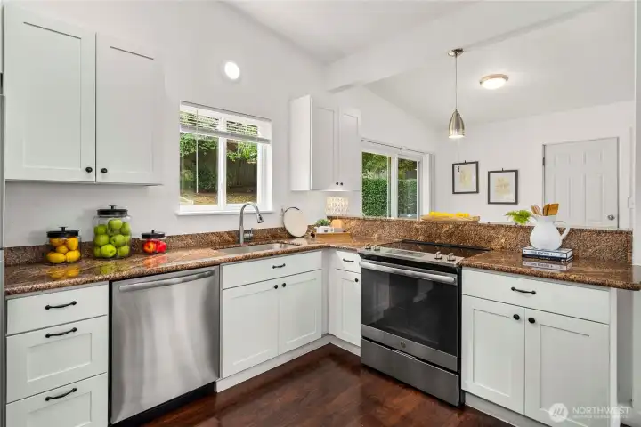A chef's delight with durable countertops, large sink and extended faucet in a conversation kitchen.