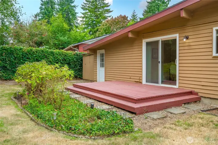 Lovely step down deck and rose garden.