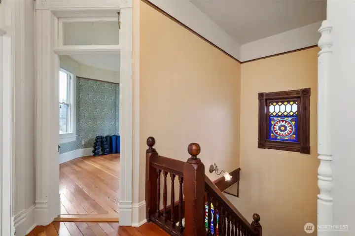 On the second level, the grand stairway opens up to the main bedroom on the right- full width of the home.