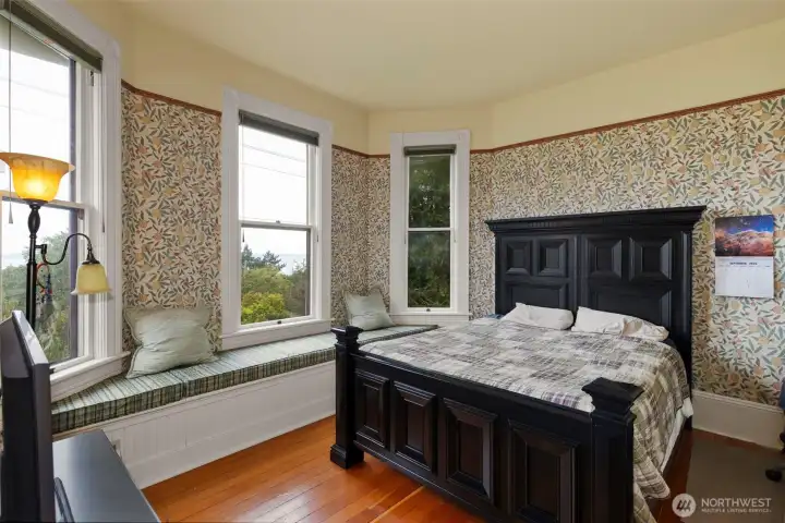 The second bedroom on the second floor features a beautiful view and lots of light. the golden fir floors and window seat again, set the room apart from modern homes.