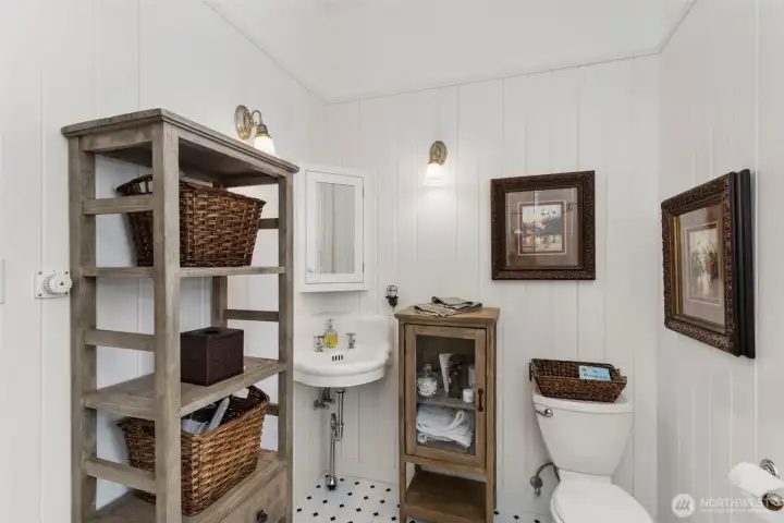 The upstairs bathroom and walk in shower with glass wall and crisp, clean tile work.