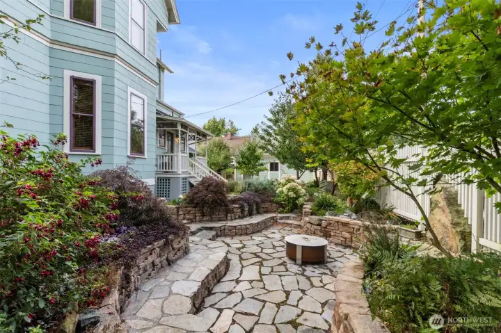 Follow the paths long enough and you'll wind around to The sunken firepit. the lighting in the evening is incredible, with imported stone worked and laid with care. This is not a project home, this is the final product!