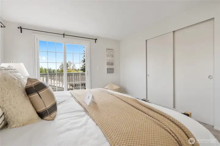 Primary bedroom with large windows and large closet
