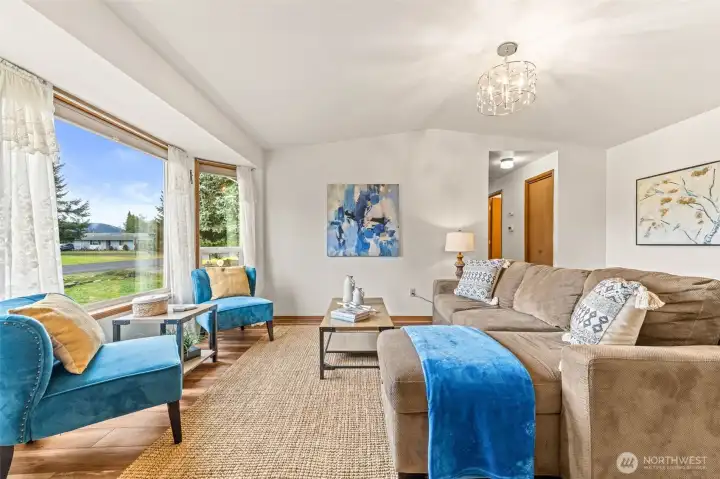 The living area lives large with high ceiling, LVP flooring and lots of natural light.