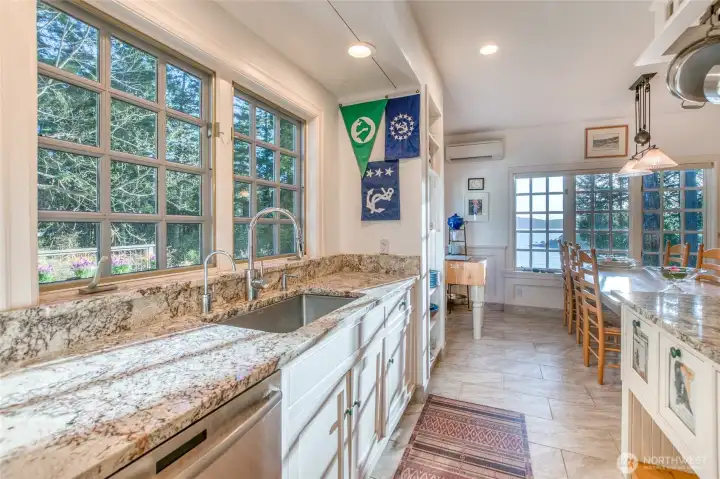 Kitchen sink area with views of deck and garden