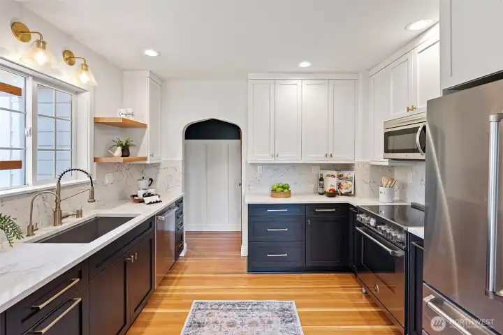 Farm sink, floating shelves. Classic and elegant kitchen!
