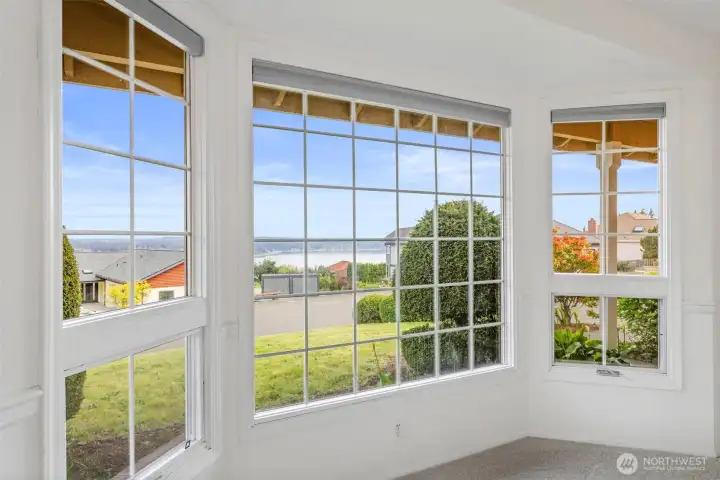 Living room view. Sky has been digitally replaced. Photo was taken on a cloudy day, so Mt. Rainier was not visible. Schedule a showing to see the real view.