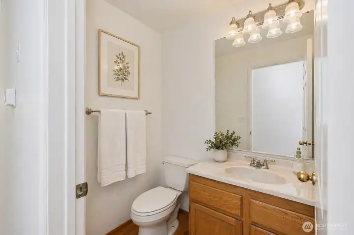 Main floor 1/2 bath. Digitally staged.