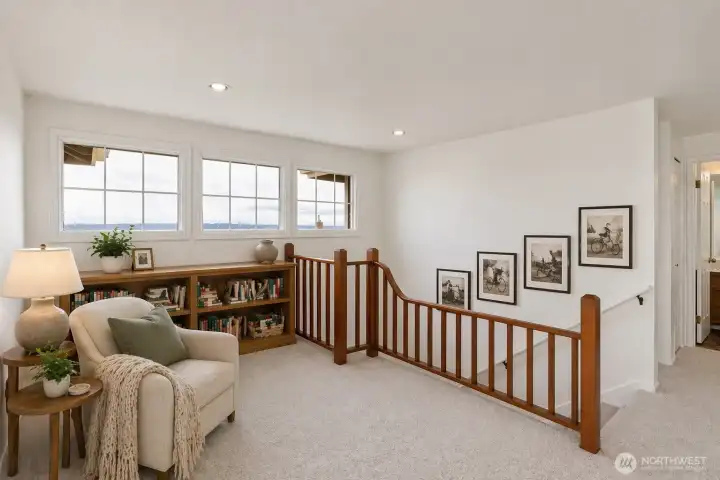 Upstairs loft area. Digitally staged.