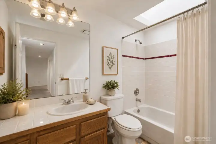 Upstairs hall bath, digitally staged.