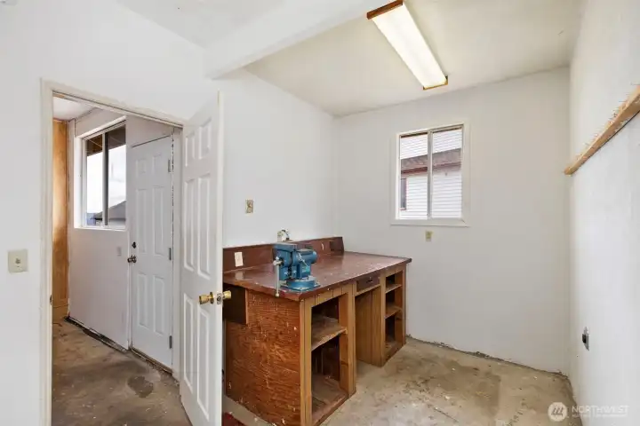 Shop with door at back of garage. A second storage/shop area opens to the back yard.