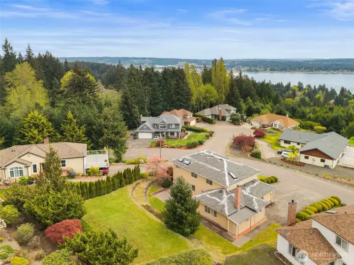 Arial view shows clean roof and gutters with seasonal maintenance already done! Additional storage for yard tools in shop area that opens to the back yard. This area is in the lower right of this photo. Note where the roof line changes near the chimney.
