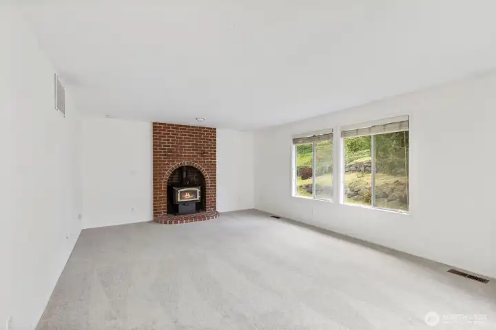 Family room with wood stove. Windows face the backyard