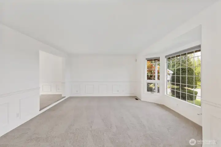 Living room is sunken, with one stair up to the dining area. Windows face east for a view of Dyes inlet, the Cascades, and Mt. Rainier.