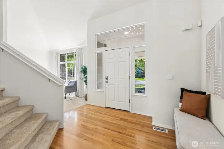 Entry with vaulted ceilings, hardwood floors