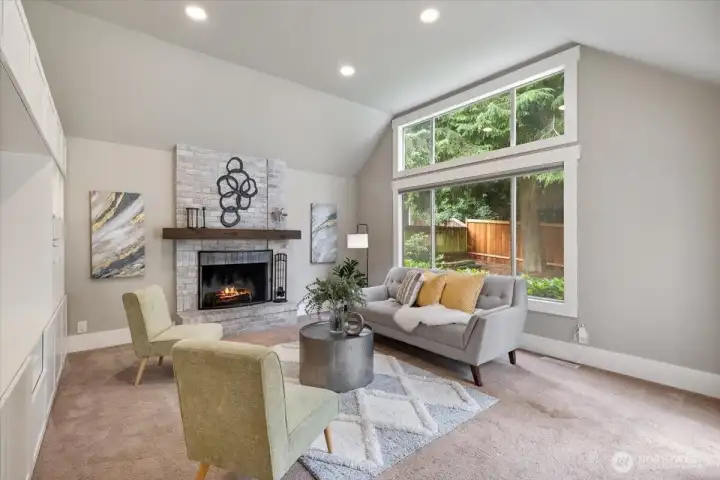 Open, vaulted ceilings in the family room with wood burning fireplace.  Easily can convert to gas if desired!