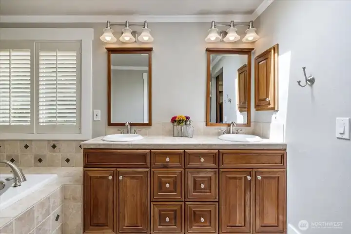 Dual vanity, with warm cabinetry.