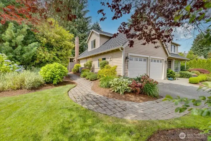 Side yard shot with the landscaping, walk-way, and Central Air conditioning unit!