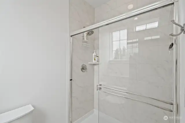 Separate commode room with low step shower.
