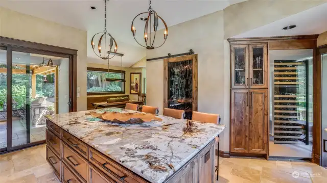 Note the Subzero 144 bottle wine cuvee.  Walk-in pantry and microwave cabinet behind the reeded glass barn door.