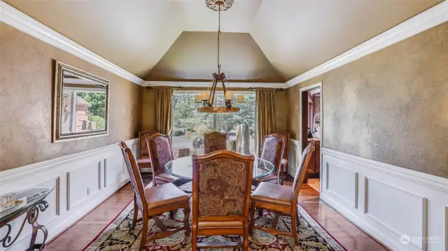 High tray ceiling, marble-faced fireplace, deep crown molding and wainscoting create an inviting space for special family gatherings and dinner parties.