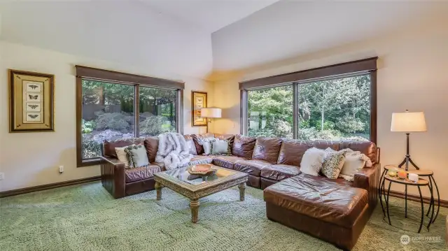 High ceiling and walls of windows bring the outdoors in. Window blinds are remote-controlled.