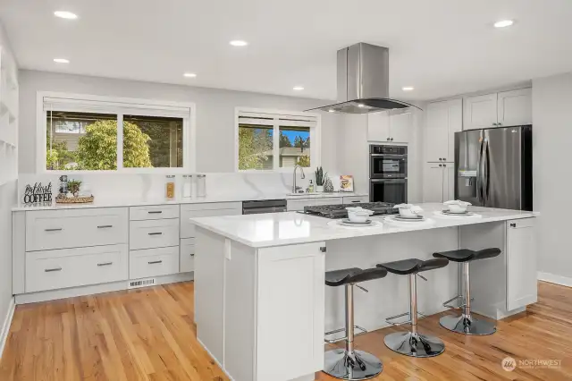 Open concept kitchen with large quartz island