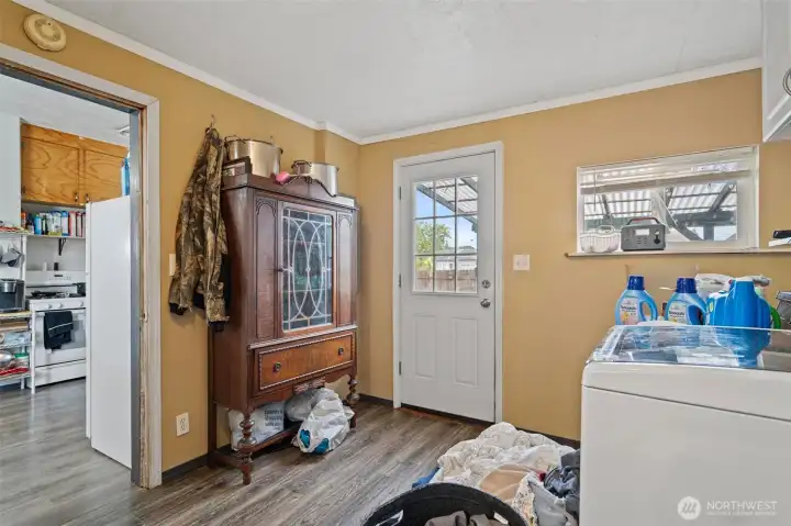 Utility room with back door entrance.