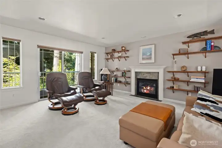 Light filled living room with cozy gas fireplace.