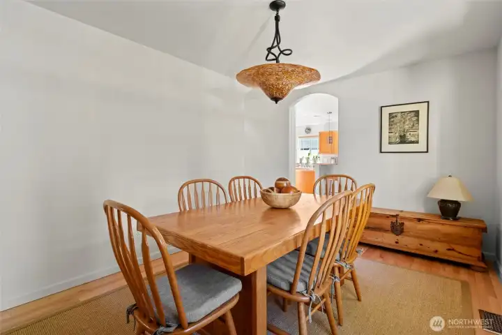 Spacious dining room with Glasslight Sudio light fixture featuring hand-blown glass shade & hand-bent metal hanger!