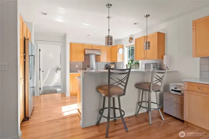 Bright cheery kitchen with eating bar.