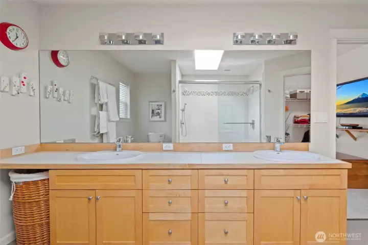 Updated primary ensuite bathroom with dual sinks and heated towel bar.