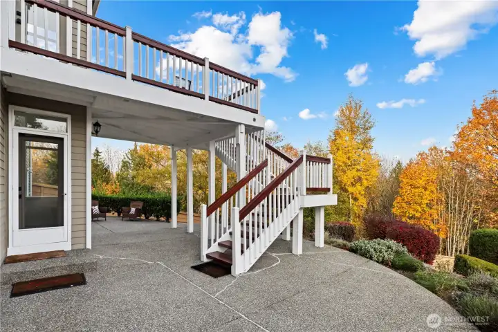 Patio with stairs leading back up to the kitchen