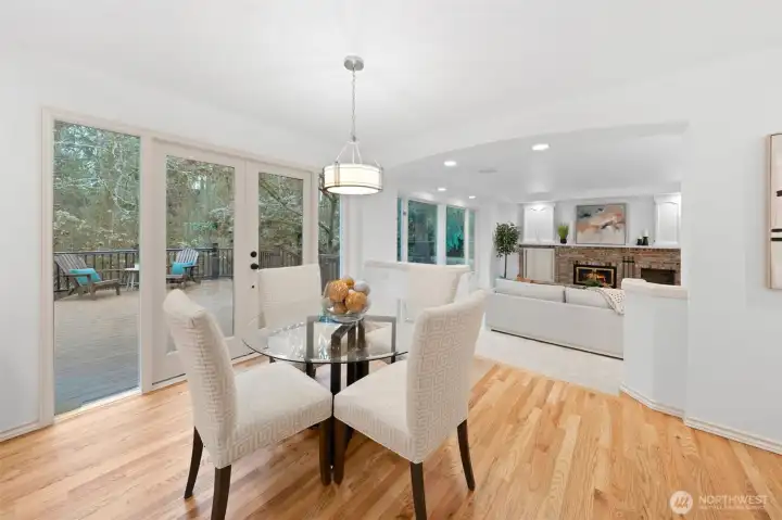 Casual dining nook features hardwood floors and a modern light fixture, offering direct access to the outdoor deck—perfect for morning coffee or easy indoor-outdoor entertaining.