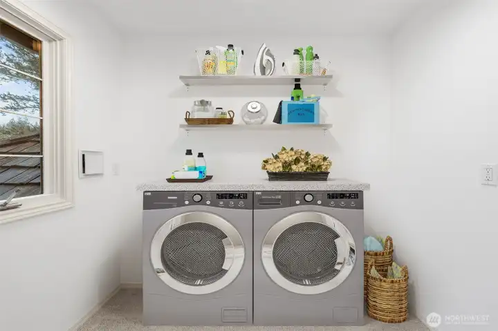 Upper-level laundry space with existing plumbing in place for a future washer and dryer, offering flexibility for customization. Image has been virtually staged to illustrate potential layout and use.