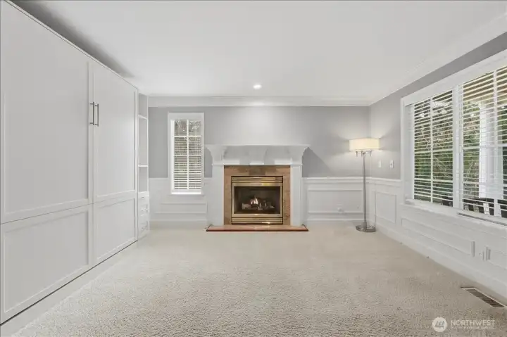 Living room or use as den/office. Built-in murphy bed on the left.